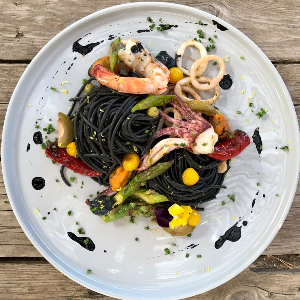 Squid ink pasta with calamari and prawns