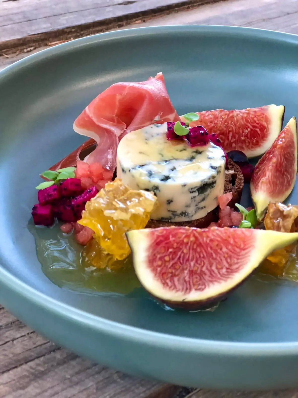 Starter of figs, cured ham, blue cheese and honeycomb