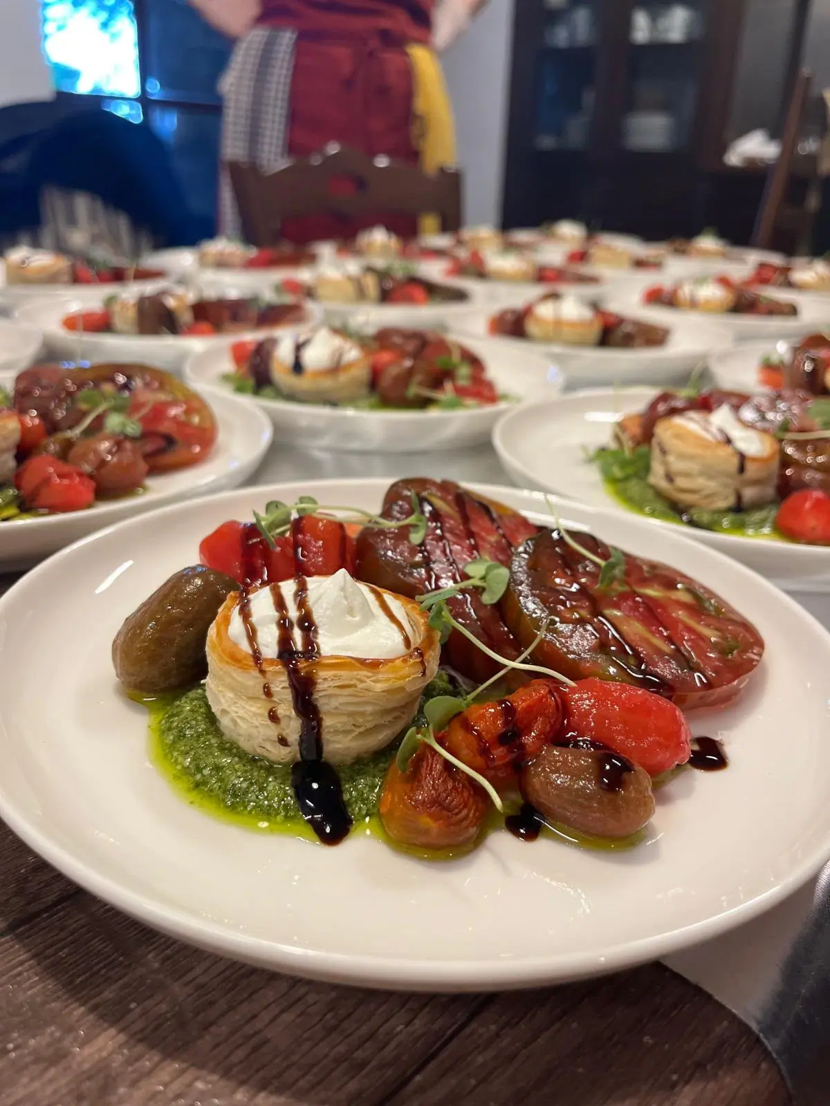 Plates of burrata and tomatoes ready to serve