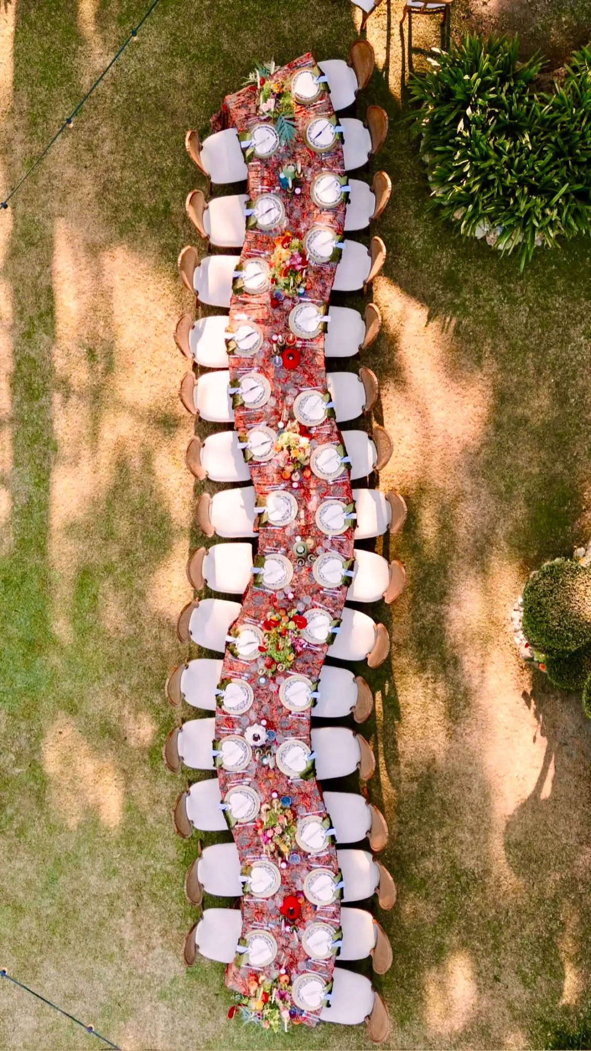 Aerial view of a long event table on the lawn