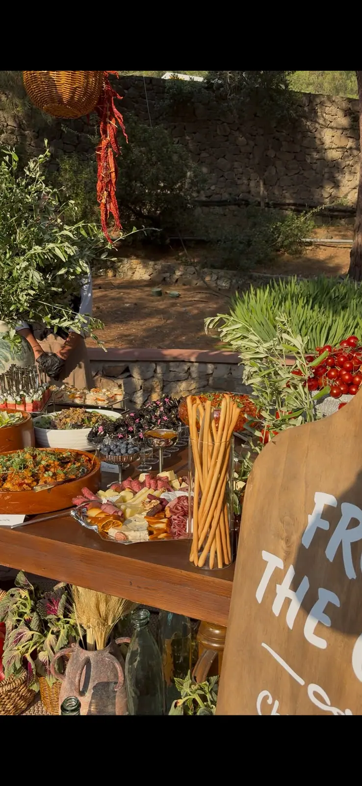 Grazing table and grill station by a garden wall